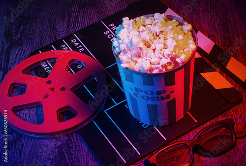 Cinema movies concept background, with a pop corn bucket, 3D glasses. Movie night template, table top photography commercial shot, with a retro purple, aesthetic.