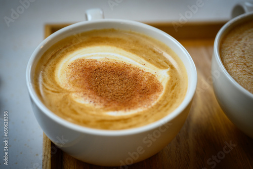 Cappuccino with cinnamon on top served in a white cup