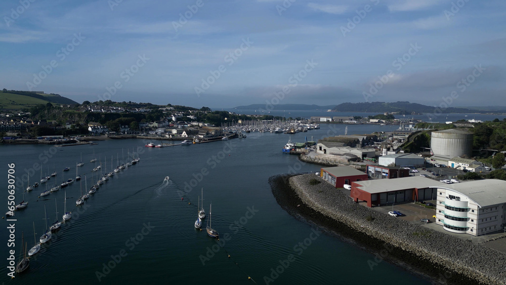 Plymouth, Devon, England: DRONE VIEWS: River Plym: Riverside warehouses, factories, docks and yacht moorings; Mount Batten, Drake's Island & Plymouth Sound on the horizon. Plymouth is a busy UK port.