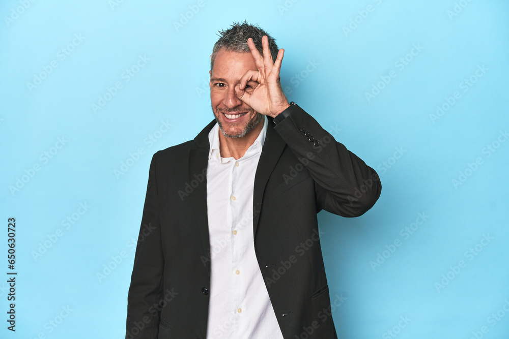 Caucasian businessman, middle-aged on blue background Caucasian businessman, middle-aged on blue background