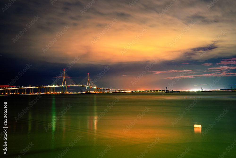 Incheon Bridge or Incheon Daegyo Expressway over the Yellow Sea at night in South Korea, linking Yeongjong Island with the mainland, built in multi-sections to withstand earthquakes