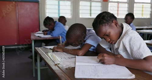 Wallpaper Mural Close-up. Black African school children drawing at a desk in a classroom in Africa  Torontodigital.ca