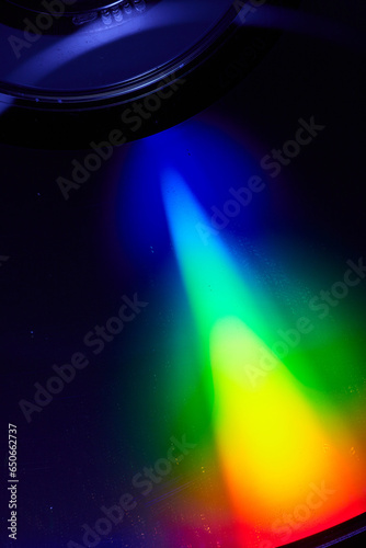 Black alien like saucer with rainbow beam of light abstract art background asset photo