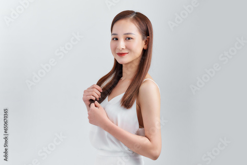 Young beautiful asian woman wearing casual dress standing over white background happy face smiling