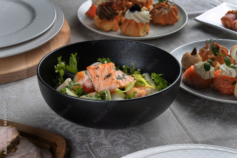 Salmon steak, squid, shrimp with salad to the New Year's table. Top view, macro Salmon steak, squid, shrimp with salad to the New Year's table. Top view, macro