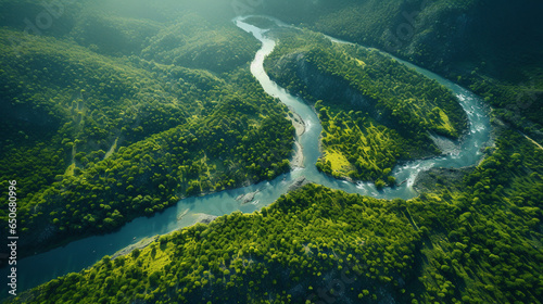 a beautiful bird's eye view of a winding river amidst green forest and hills