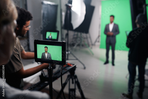 Photos Videomaker shooting journalist for broadcast in professional studio