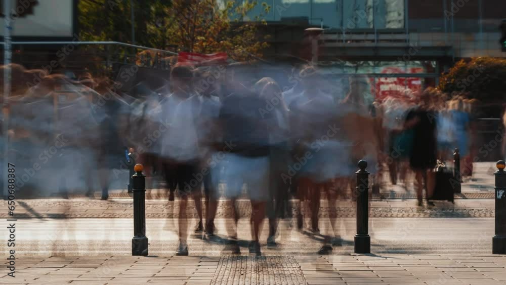 Time-lapse unrecognizable people crowd crossing city street, busy crossroad, blurry pedestrians crossing crosswalk intersection on summer day. Rush hour lot of people walk, blurred fast motion