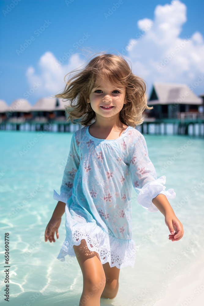 Maldives Elegance: Little Girl in White Emerges from Ocean Bliss Maldives Elegance: Little Girl in White Emerges from Ocean Bliss