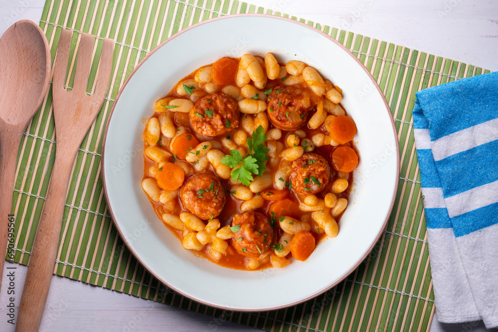 White bean stew with chorizo. Traditional dish of Spanish gastronomy from the Asturias region in the north of the country. White bean stew with chorizo. Traditional dish of Spanish gastronomy from the Asturias region in the north of the country.
