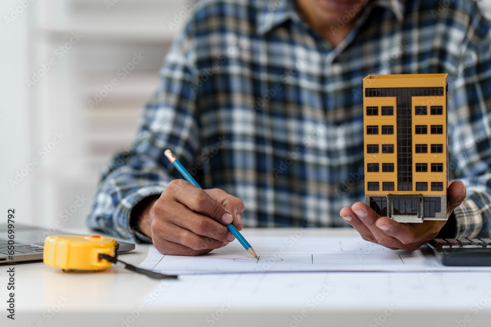 Architect engineer drawing plan blueprint of condominium or apartment ...