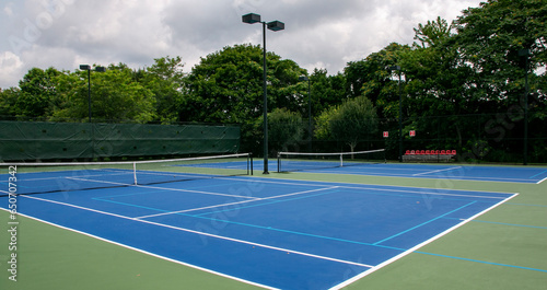 Cross court view of pickleball tennis courts painted blue and green