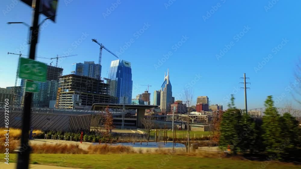 Pov Panning Shot Of Bridge Near Modern Buildings At Downtown In City Against Sky - Nashville, Tennessee Pov Panning Shot Of Bridge Near Modern Buildings At Downtown In City Against Sky - Nashville, Tennessee