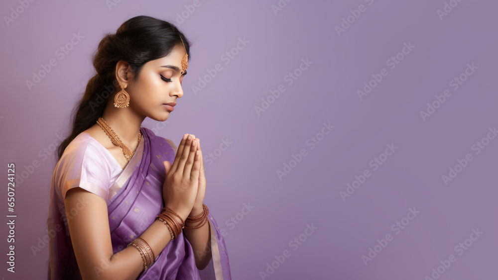 Obraz premium Indian Woman in purple sari cloth praying, greeting diwali celebration
