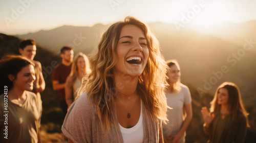 Tablou canvas Young woman leading a group of people in laughter yoga session on a mountaintop