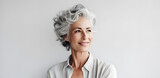 Beautiful mature elderly woman portrait isolated on light grey background