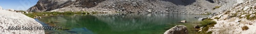 Panorama shot of clear water in Scout Boys lake with white granite rockc around at sunny day, usa