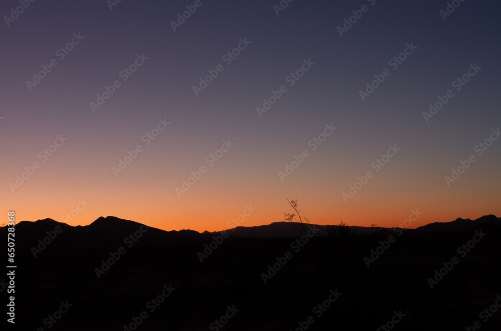 Panorama shot of colorful sunset with black mountains horizon in american nature, Mount Whitney