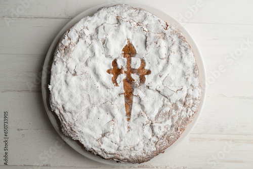 The Tarta de Santiago is the most typical sweet of Galician cuisine and is easily recognized by its emblematic Cross of Santiago in the center. photo
