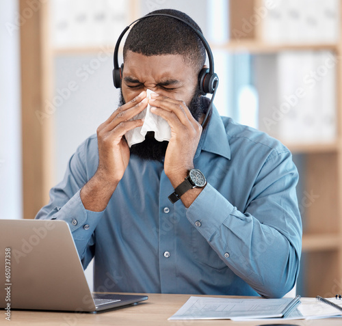 Black man, sick and call center blowing nose with tissue, allergy or flu in customer service at office. African male person, consultant or agent with cold, symptoms or immune virus at workplace