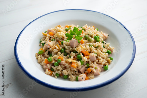 Traditional Chinese fried rice with 3 delicacies with peas, ham and other vegetables.