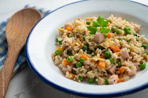 Traditional Chinese fried rice with 3 delicacies with peas, ham and other vegetables.