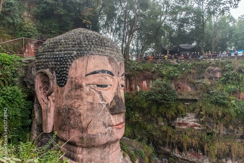 Discover the colossal Leshan Giant Buddha, a 71-meter stone statue in Sichuan, China, a UNESCO World Heritage Site. photo