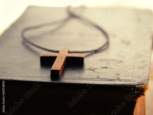 Holy bible with wooden crucifix cross close up 
