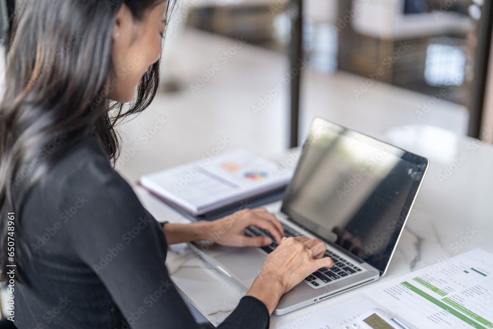 Beautiful confident asian business woman working with laptop Hands typing keyboard. Professional investor working new start up project. business planning in office. Technology business Beautiful confident asian business woman working with laptop Hands typing keyboard. Professional investor working new start up project. business planning in office. Technology business