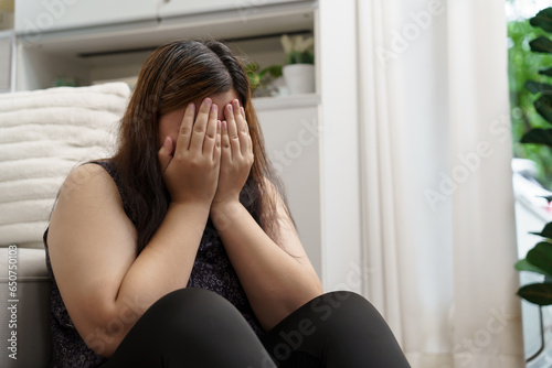 Sad Overweight plus size woman thinking about problems on sofa upset girl feeling lonely and sad from bad relationship or Depressed woman disorder mental health © Charlie's