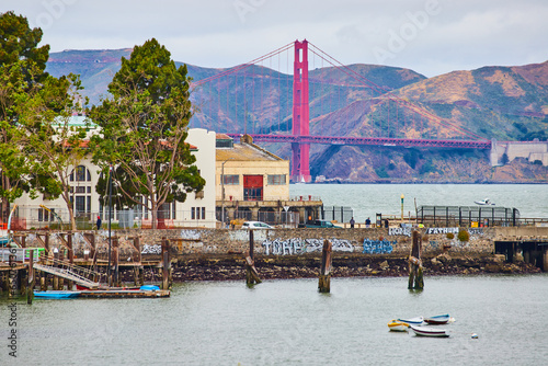 Vászonkép San Francisco bay with tiny rowboats on water with shoreline and Golden Gate Bri