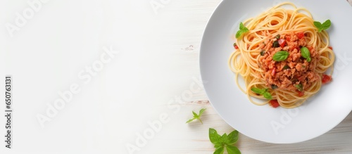 Minimalistic aerial view of a white plate with vermicelli and meat a classic Russian pasta dish on a light fabric backdrop isolated pastel background Copy space