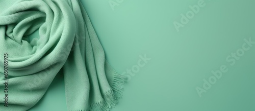Gorgeous green wool scarf on isolated pastel background Copy space