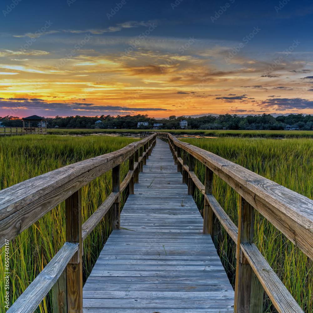 wooden dock on the inlet at Pawleys Island in South Carolina at usnset
