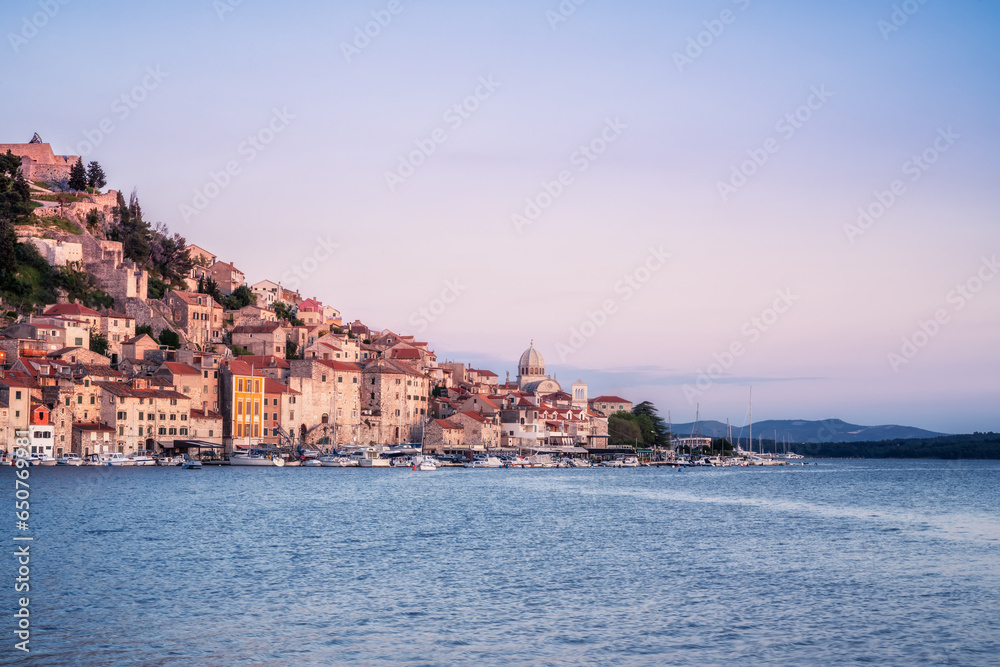 Amazing view in the blue hour after sunset with the picturesque buildings of the old town of Shibenik at the Adriatic sea coast in Croatia.