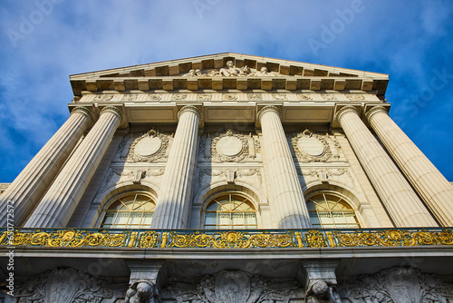 Photography Sunlight hitting pillars and windows on city hall entrance up close with blue sk