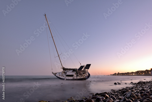 velero encallado en una playa de Marbella  photo
