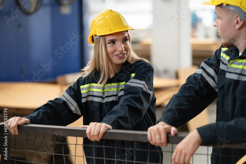 Fotografie Caucasian engineer man and woman checking brown paperboard in office at paper fa