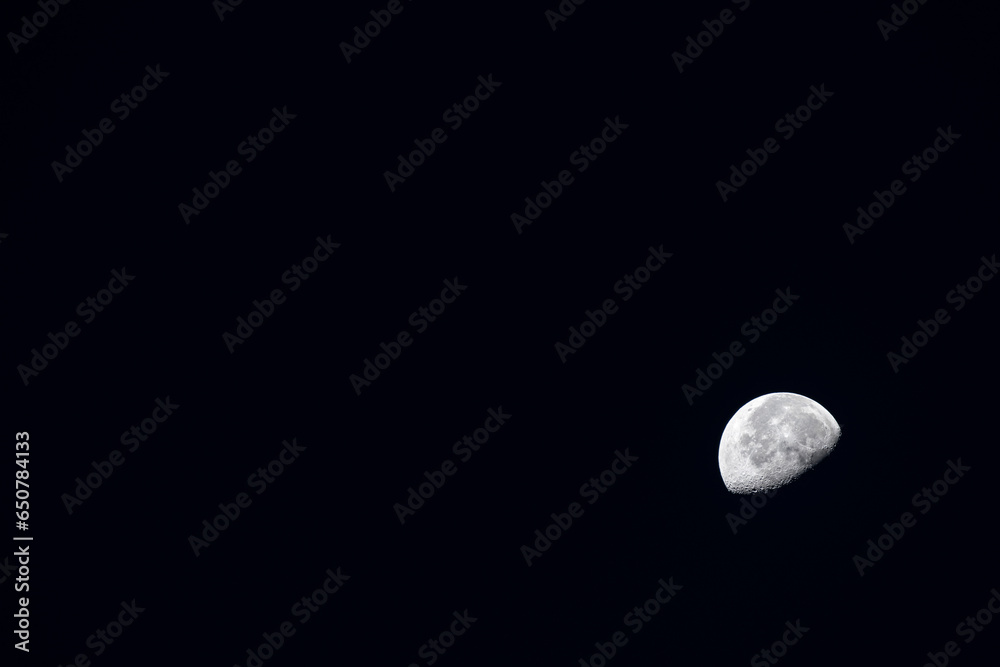 Half moon against the black night sky, offering large copy space for customisation with title, text, or any graphic element. Ideal for celestial themed designs Half moon against the black night sky, offering large copy space for customisation with title, text, or any graphic element. Ideal for celestial themed designs