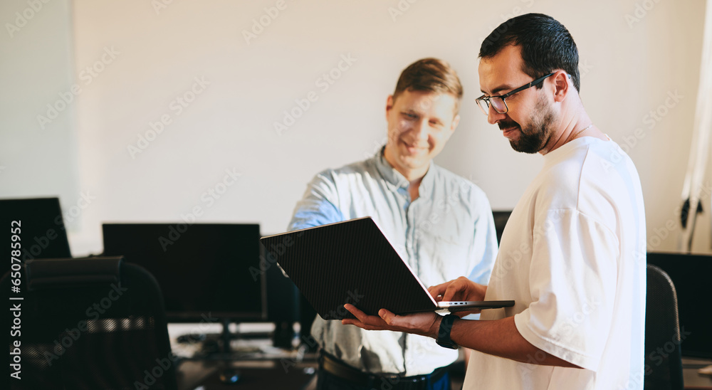 Portrait of two professional male programmers working on computer in diverse offices. Modern IT technologies, development of artificial intelligence, programs, applications and video games concept