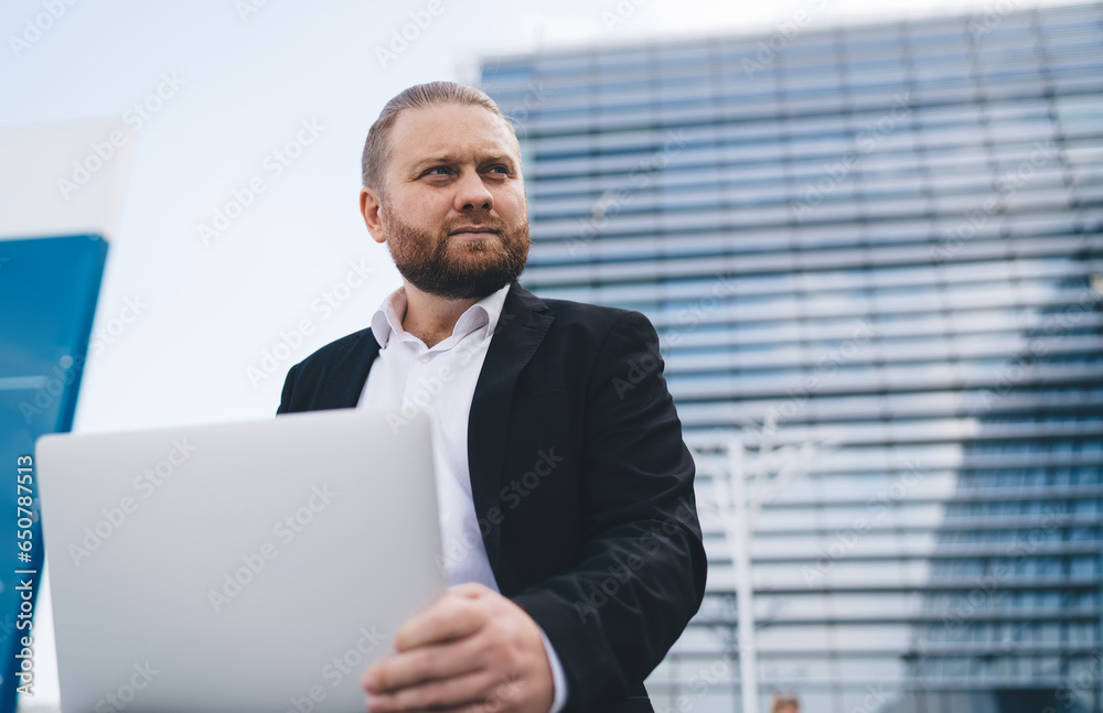 Thoughtful young businessman using laptop Thoughtful young businessman using laptop