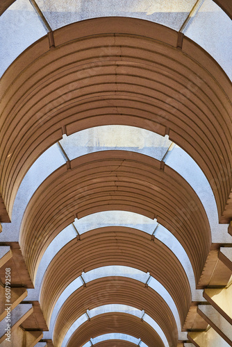 Symmetrical tunnel ceiling with optical illusion openings for sunlight