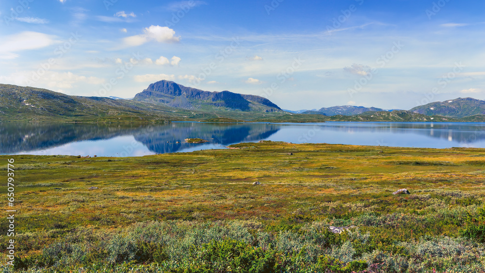 Summer panorama scenery in Jotunheimen national park in Norway, mountains and lake