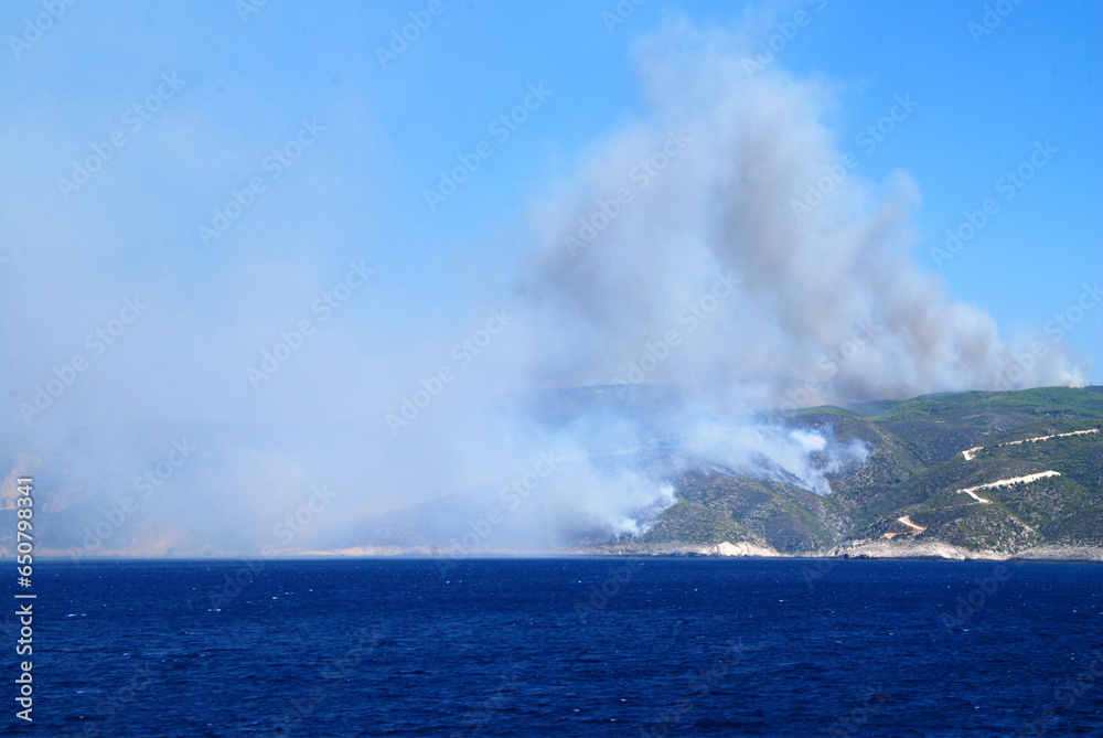 Fototapeta premium wildfire on greek island seen from ferryboat