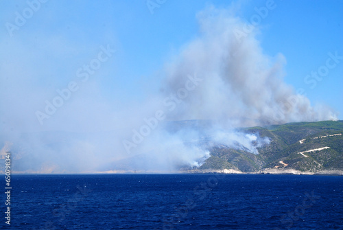 wildfire on greek island seen from ferryboat