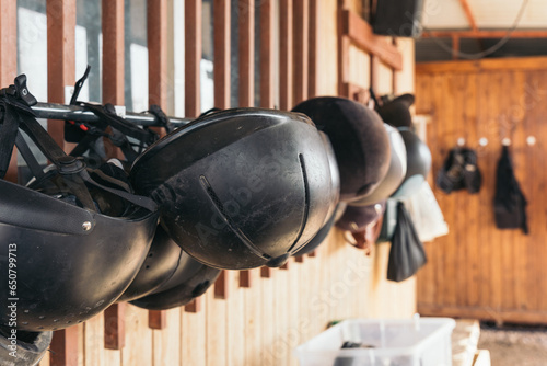 Photography Row of rider's helmets for riding horses in the equestrian arena