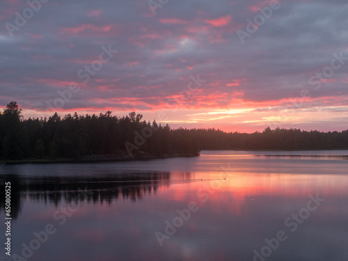 Fototapeta Naklejka Na Ścianę i Meble -  dramatic sunset on a forest lake