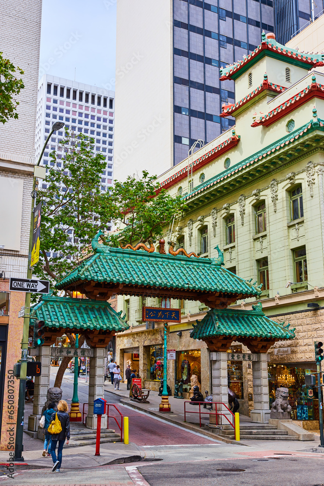 San Francisco elaborate Chinatown entrance with pedestrians and shops San Francisco elaborate Chinatown entrance with pedestrians and shops