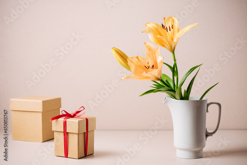 Orange lily flowers and gift box.