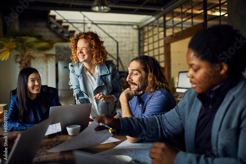 Young and diverse group of designers having a meeting in an office while working in a startup company